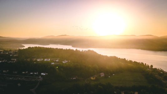 Body Of Water Beside A Green Land Formation photo