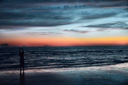 Silhouette Of Person On Seashore During Golden Hour photo