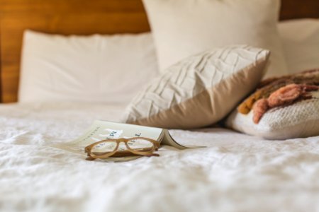 Eyeglasses With Brown Frames On White Textile photo