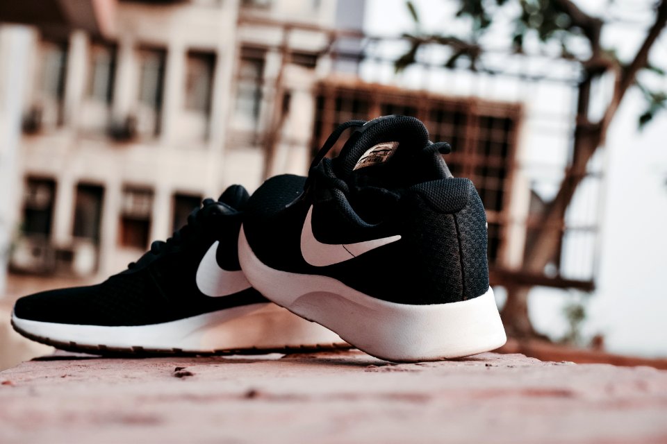 Macro Photography Of Pair Of Black-and-white Nike Running Shoes