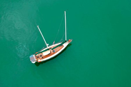 White Sailing Boat On Body Of Water photo