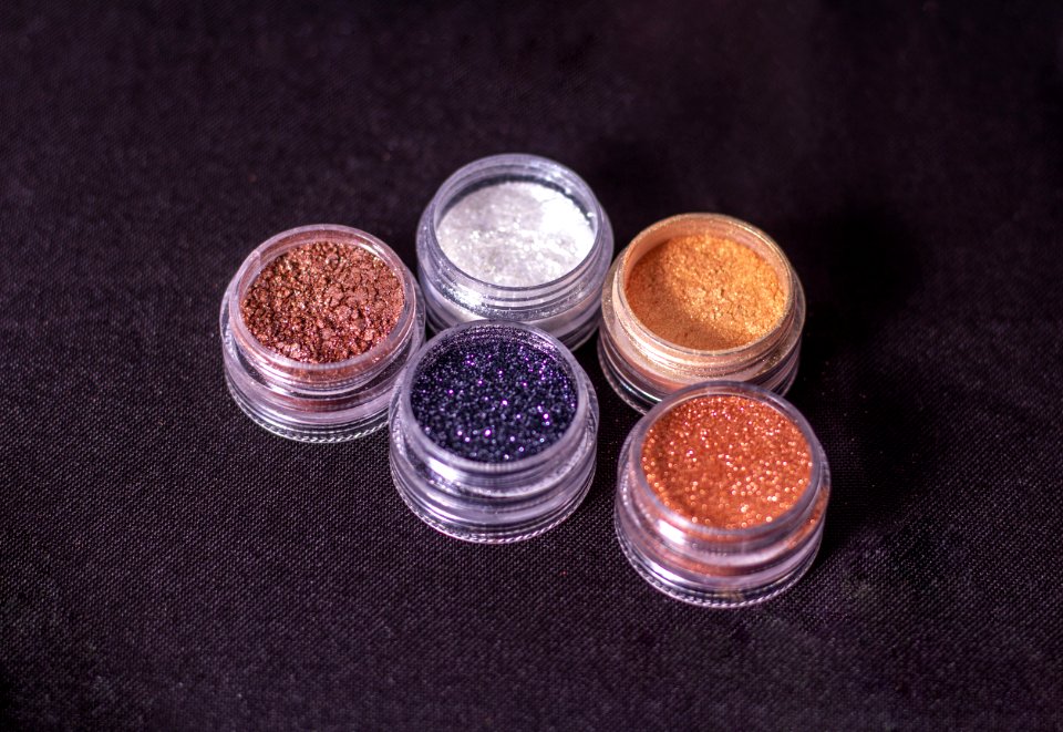Close-Up Photo Of Glitters On Round Containers