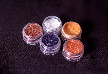 Close-Up Photo Of Glitters On Round Containers