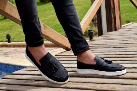 Person Wearing White-and-black Leather Slip-on Shoes With Tassels