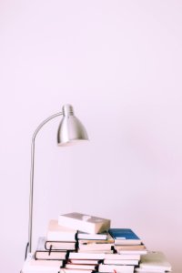 Silver Desk Lamp Near Pile Of Books