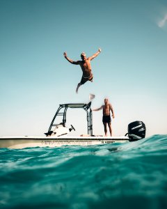 Photo Of Man Jumping From Boat To The Sea photo
