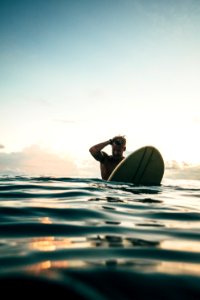 Man Holding White Surfboard photo