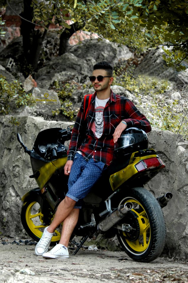 Man In Black Sunglasses Leaning Black Sportbike