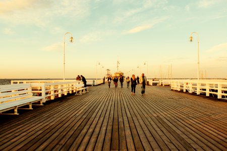 People Walking On Board Walk photo