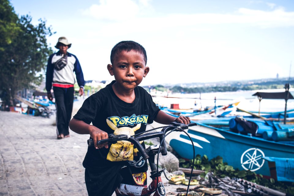 Boy Riding On Black Bicycle