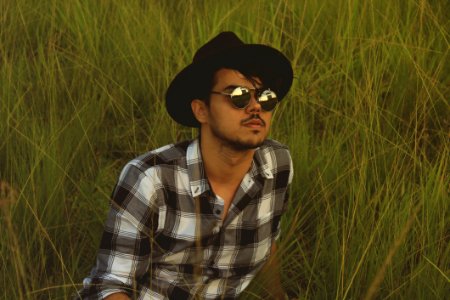 Photo Of Man Lying Down On Green Grass Field