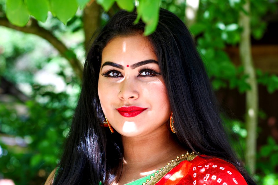 Woman Wears Red Top Under Green Tree At Daytime