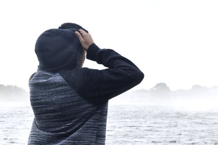 Person In Black And Grey Raglan Hoodie Near Body Of Water photo