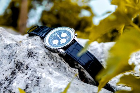 Selective Focus Photography Of Chronograph Watch On Rock