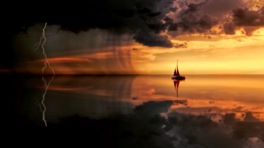 Silhouette Photography Of Boat On Water During Sunset photo