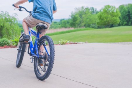 Person Riding Blue Bicycle