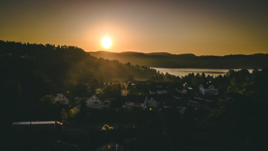 Village Near Mountain And Body Of Water photo