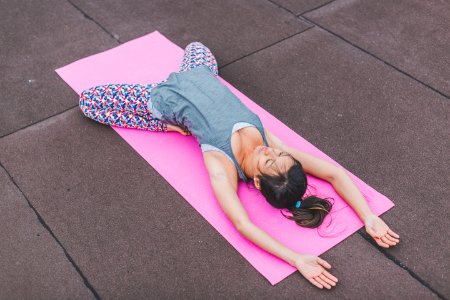 Woman Lying On Pink Yoga Mat photo