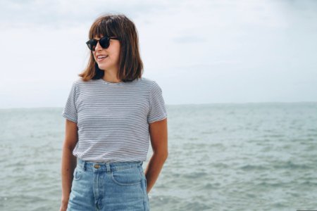 Woman Standing Near Sea While Wearing Black Frame Sunglasses photo