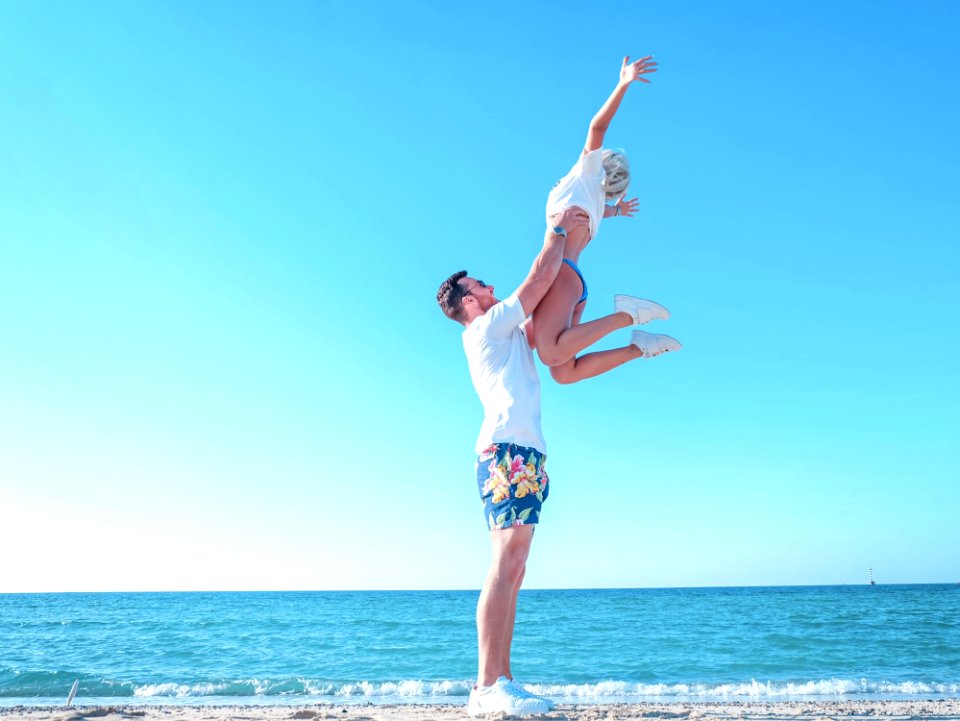 Man Holding Woman Near The Sea