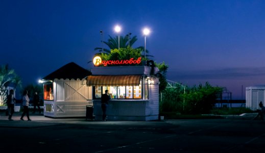 White Food Stall With Lights Open During Nighttime