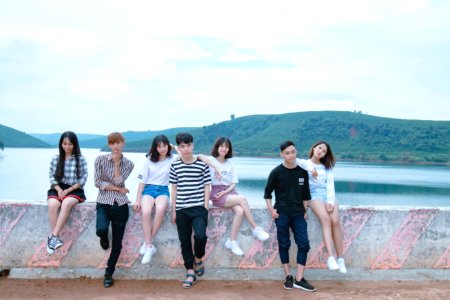 Photo Of Four Women And Three Men Standing On Bridge photo