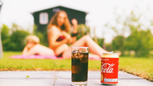 Coca-cola Can And Drinking Glass Filled With Coke photo