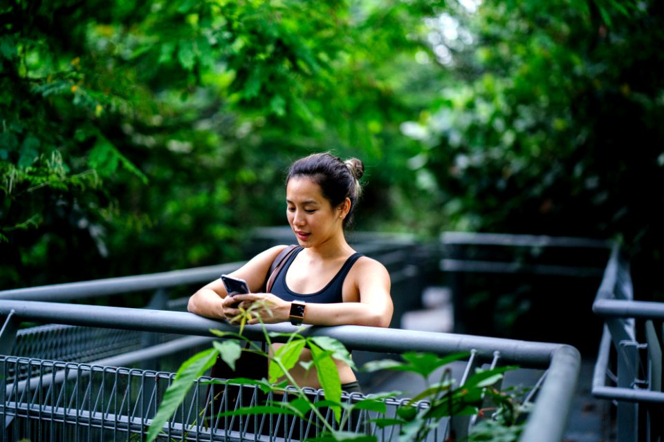 Woman Wearing Sports Bra Looking At Phone