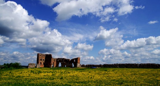 Brown Wall On Green Field Under Clouds