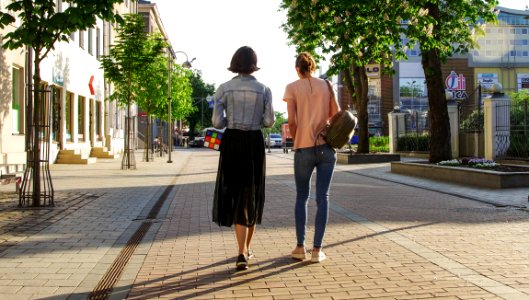 Photo Of Women Walking Down The Street photo