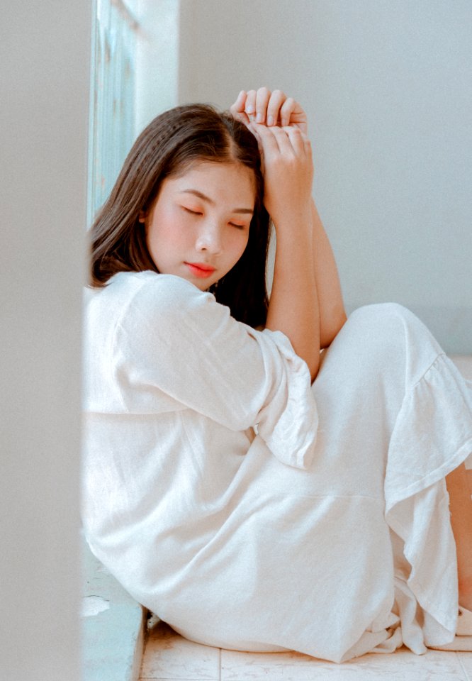 Woman Sitting Wearing White Dress photo