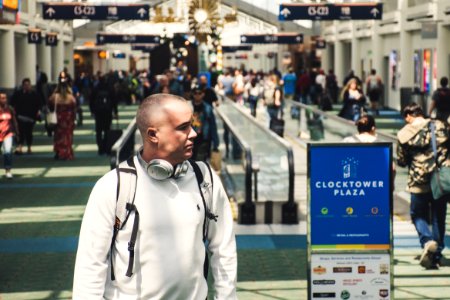 Man Walking Near Clocktower Plaza Signage photo