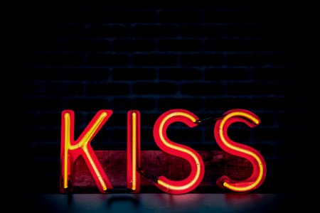 Red Kiss Neon Light Signage On Dark Lit Room photo