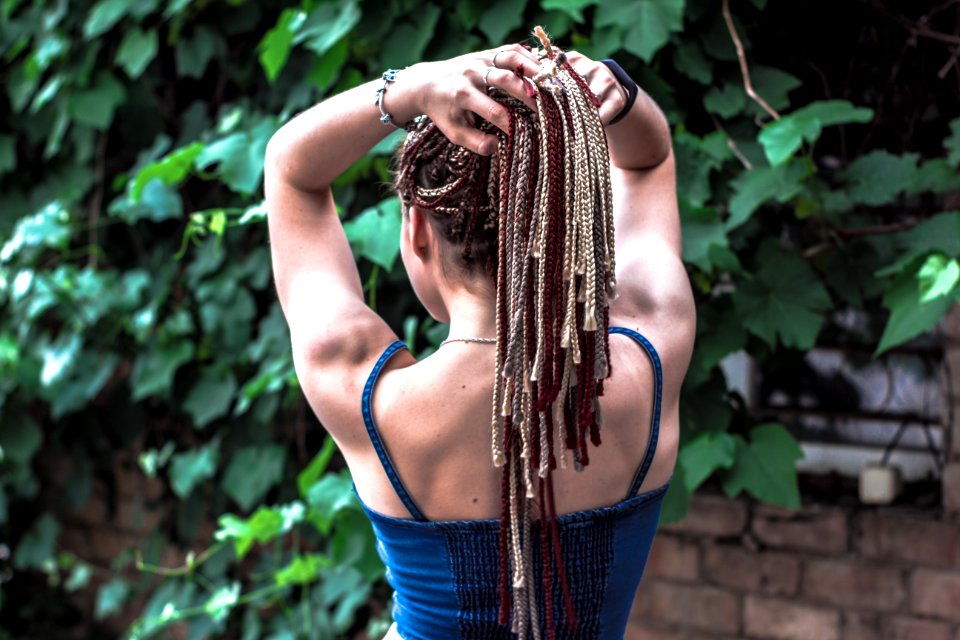 Woman Facing Brown Brick Wall