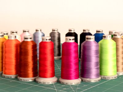 Assorted Sewing Threads On Greensurface photo