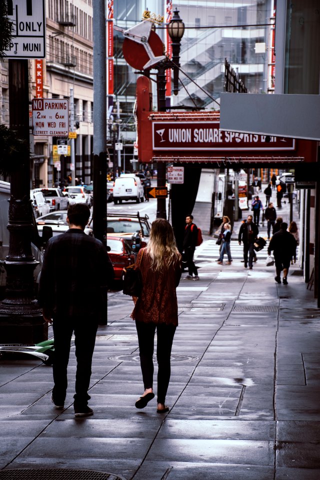 Man And Woman Walk Beside Store photo