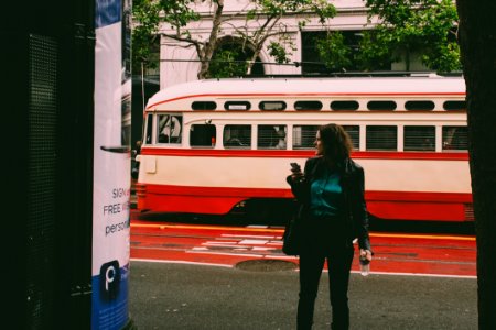 Woman Wearing Black Blazer Beside White And Red Cable Cab photo