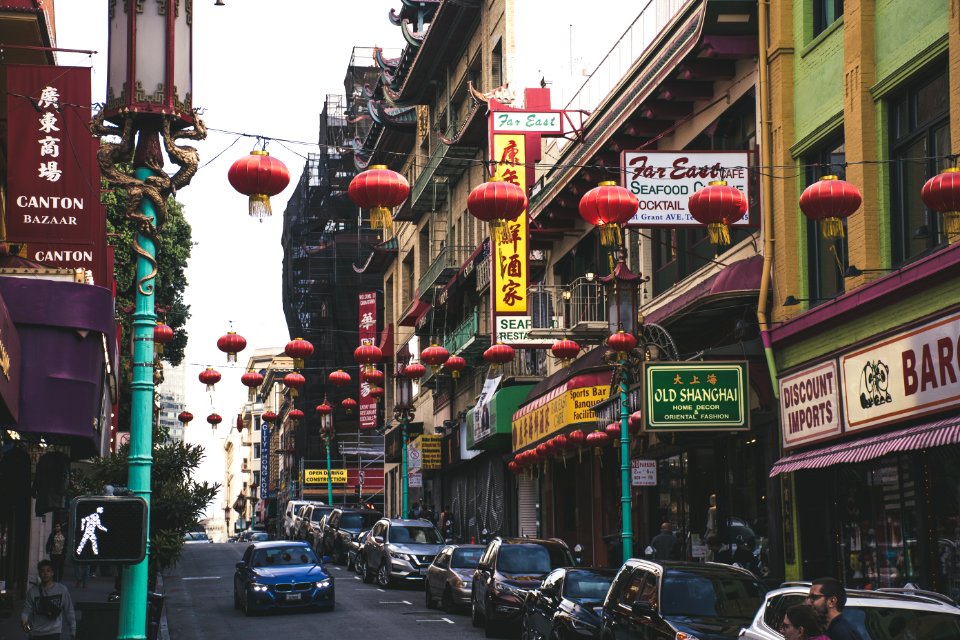 Vehicles Parked Beside Buildings Under Red Chinese Lanterns photo