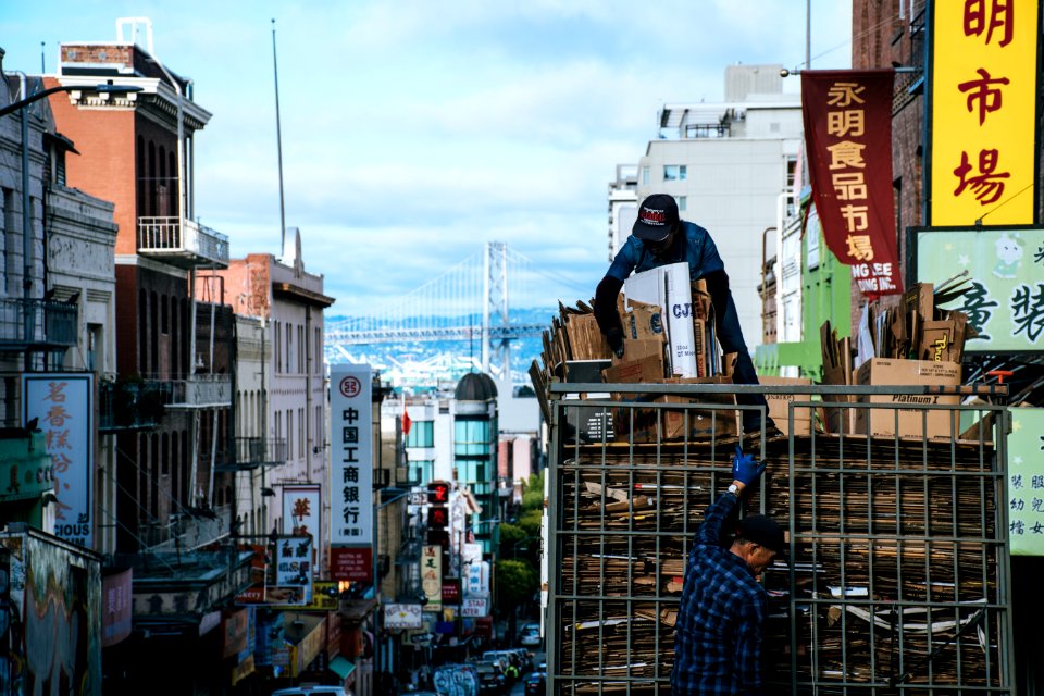 Man On Top Of Truck Arranging Brown Cardboard Boxes