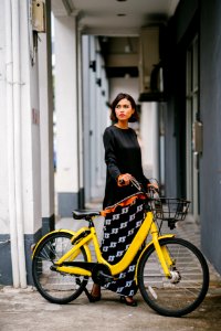 Woman Holding Yellow Bike At Daytime photo