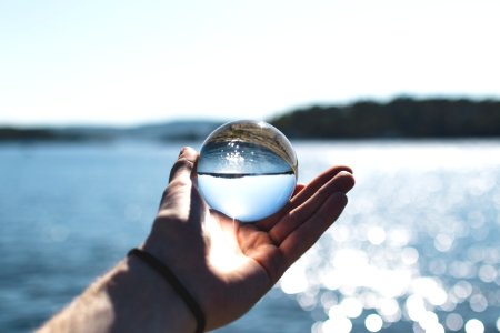 Selective Focus Photography Of Person Holding Water Bubble photo