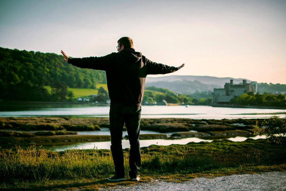 Man Wearing Black Jacket Near On Body Of Water