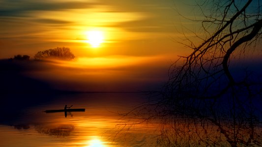 Man Riding Boat During Sunset photo