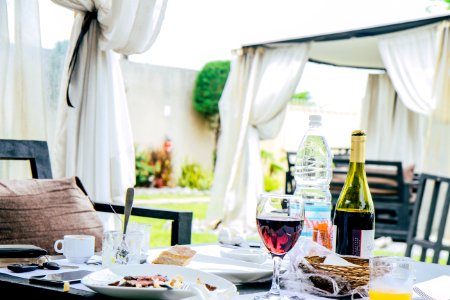 Table Full With Plate Of Foods Wine Bottle And Mugs photo