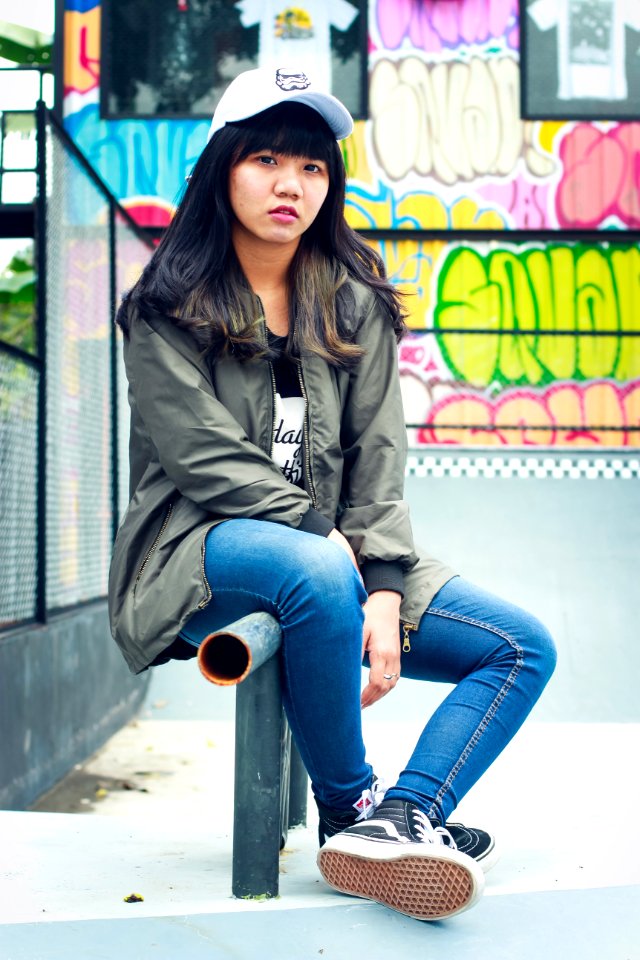 Woman In Black Zip-up Jacket Sit On Black Metal Rail
