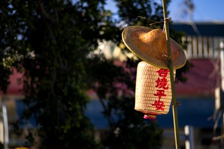 Straw Hat And Paper Lantern Placed On Bamboo Pole