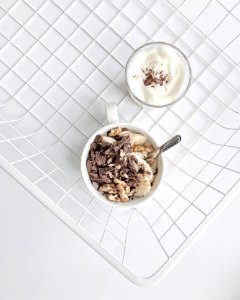 Crushed Nuts And Chocolates On White Ceramic Mug High-angle Photography photo