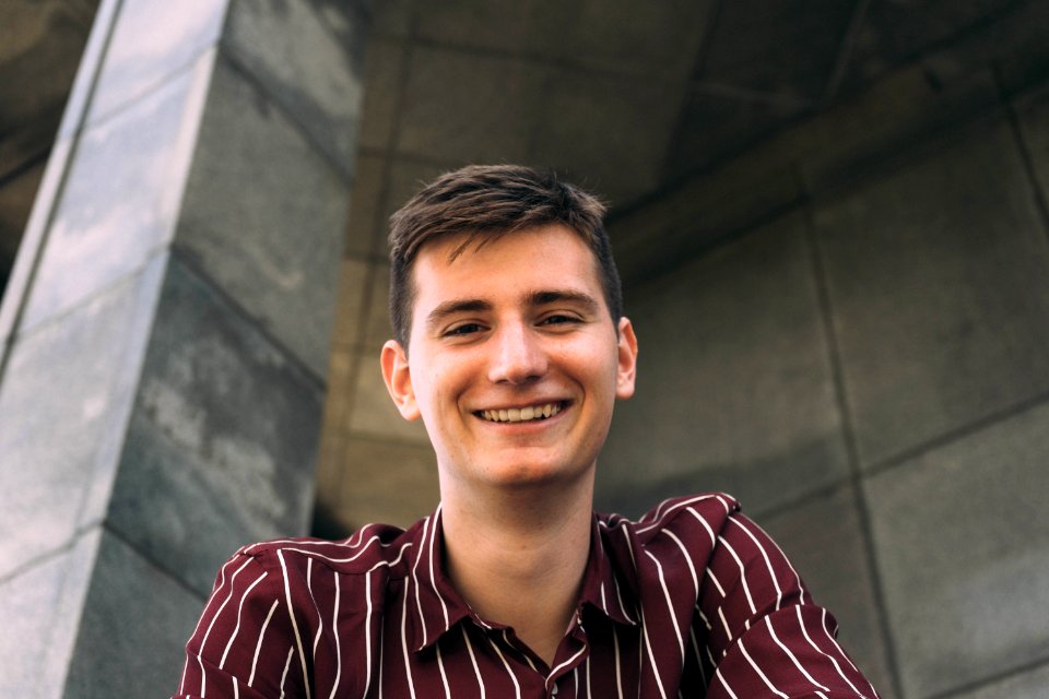 Man In Red And White Striped Collared Shirt Smiling