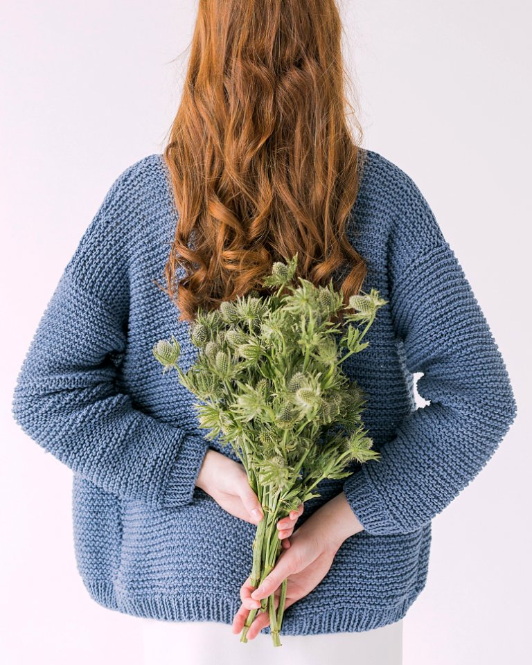 Woman In Gray Sweater Holding Green Leaf Plants