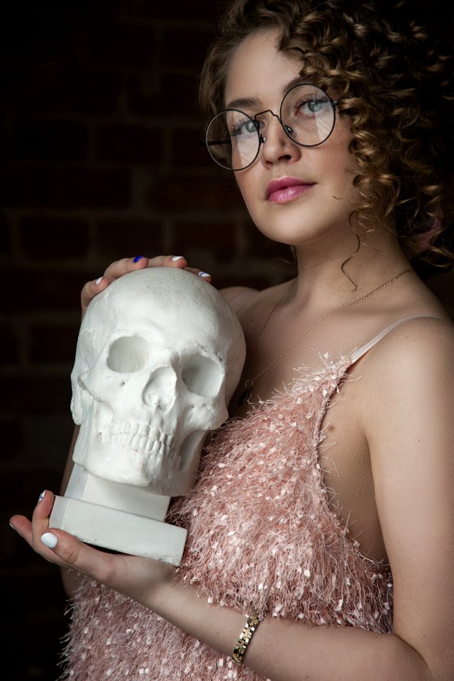 Woman Holding Skull Replica